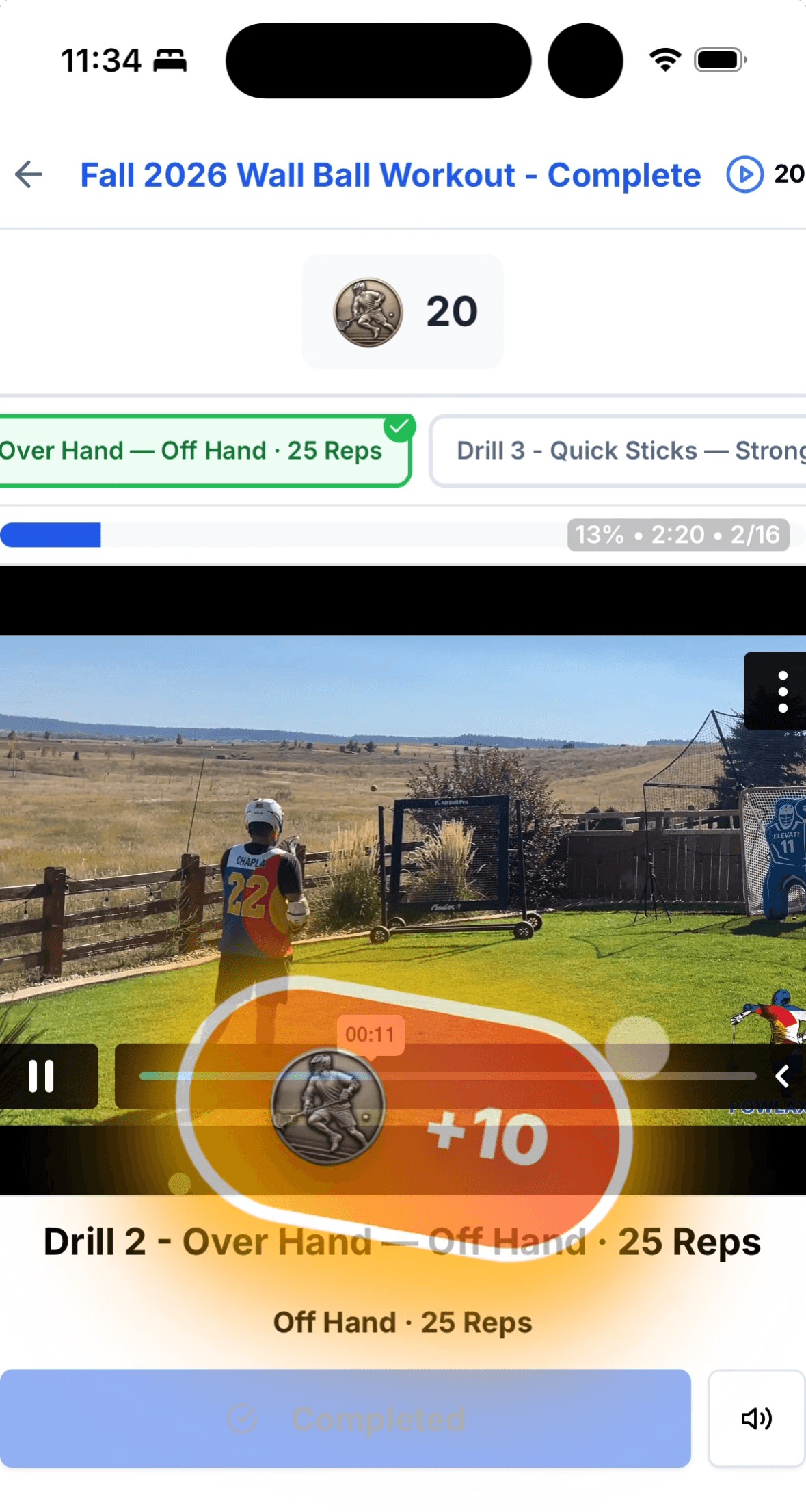 A POWLAX Skills Academy wall ball workout open on a phone: the drill video playing with the progress strip under it, the finished drill chip checked green above, and points landing on screen as the player finishes the drill.